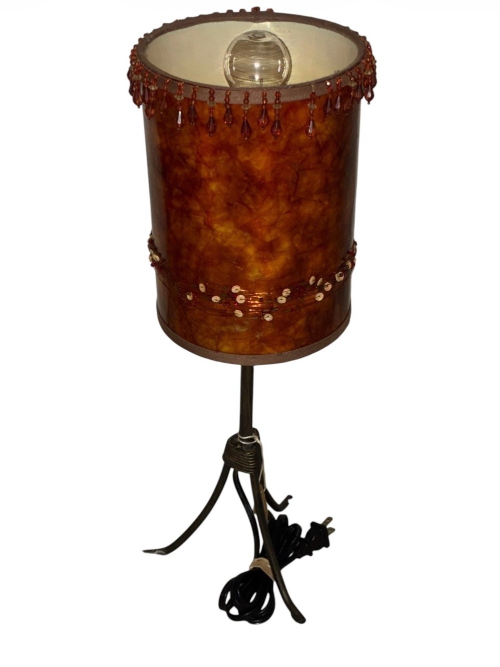 Vintage amber-color table lamp with a beaded drum shade tripod metal base.